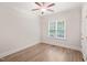 Bright bedroom features hardwood floors, a ceiling fan, and a large window overlooking lush greenery at 85 Pebble Creek Dr, Franklinton, NC 27525