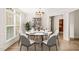 Bright dining room with a stylish table, chairs, and large windows at 85 Pebble Creek Dr, Franklinton, NC 27525