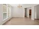 Elegant dining room with large windows, crown molding, hardwood floors, and a chandelier at 85 Pebble Creek Dr, Franklinton, NC 27525
