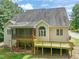 An elevated exterior view of the wooden back deck and screened-in porch of the home at 85 Pebble Creek Dr, Franklinton, NC 27525