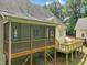 An elevated exterior view of the screened-in porch and wooden back deck of the home at 85 Pebble Creek Dr, Franklinton, NC 27525
