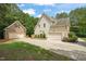 Exterior side view of home and detached two-car garage with brick veneer at 85 Pebble Creek Dr, Franklinton, NC 27525