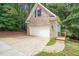 A detached two-car garage with a concrete driveway, brick veneer, and dark shutters at 85 Pebble Creek Dr, Franklinton, NC 27525
