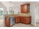Gourmet kitchen with a breakfast bar, stainless steel dishwasher, and custom cabinets at 85 Pebble Creek Dr, Franklinton, NC 27525