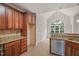 Cherry cabinets, granite countertops, and mosaic backsplash adorn this open kitchen with stainless steel dishwasher at 85 Pebble Creek Dr, Franklinton, NC 27525