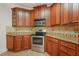 Modern kitchen with stainless steel appliances, mosaic backsplash, and custom wood cabinetry at 85 Pebble Creek Dr, Franklinton, NC 27525