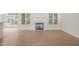 Bright living room with a fireplace, hardwood floors, and large windows overlooking the garden at 85 Pebble Creek Dr, Franklinton, NC 27525
