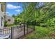Cozy backyard patio with a table, grill, and a lush green lawn surrounded by mature trees at 8611 London Park Ct, Raleigh, NC 27615