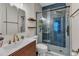 Modern bathroom with a sleek glass-enclosed shower, wood shelves, and a stylish vanity sink at 8611 London Park Ct, Raleigh, NC 27615
