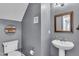 Charming half bathroom in gray features a framed mirror and modern toilet at 8611 London Park Ct, Raleigh, NC 27615