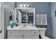 Bathroom features a large mirror, sink with vanity, and a shower/tub combo at 8611 London Park Ct, Raleigh, NC 27615