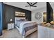 Spacious bedroom featuring a large bed, dark accent wall, and a ceiling fan at 8611 London Park Ct, Raleigh, NC 27615