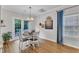 Cozy dining room with a round table, four chairs, a charming light fixture, and backyard views at 8611 London Park Ct, Raleigh, NC 27615