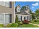 Exterior showing the light-colored siding, landscaping, black shutters, dormer windows and greenery at 8611 London Park Ct, Raleigh, NC 27615