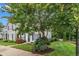 Exterior shot showcasing the well-maintained lawn and front of the townhome with black shutters at 8611 London Park Ct, Raleigh, NC 27615