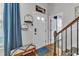 Entryway with hardwood floors, wooden stairs, bench and decor at 8611 London Park Ct, Raleigh, NC 27615