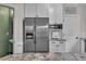 Kitchen features a stainless steel refrigerator and modern microwave and breakfast bar at 8611 London Park Ct, Raleigh, NC 27615