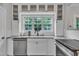 Bright kitchen features stainless steel appliances, granite countertops, and a large window at 8611 London Park Ct, Raleigh, NC 27615