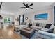 Bright living room with neutral colors, a comfortable sectional, hardwood floors, and natural light at 8611 London Park Ct, Raleigh, NC 27615