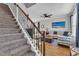Stairs to the living room with wood floors and a beige sofa at 8611 London Park Ct, Raleigh, NC 27615