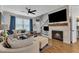 Inviting living room featuring a fireplace, TV, comfortable seating, and hardwood floors at 8611 London Park Ct, Raleigh, NC 27615