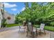Exterior shot of a backyard patio with a grill, table, chairs, and fence at 8611 London Park Ct, Raleigh, NC 27615
