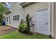 Exterior view of side yard showcasing door, turf lawn, and access to the home's patio at 8611 London Park Ct, Raleigh, NC 27615