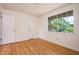 Empty bedroom with light walls, a window overlooking the yard, and hardwood floors at 1002 Willow Drive Dr # 37, Chapel Hill, NC 27514