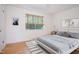 Bright bedroom with hardwood floors, a light gray bed, and a window with wood-slat blinds at 1002 Willow Drive Dr # 37, Chapel Hill, NC 27514