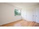 Bright bedroom with hardwood floors and a large window overlooking lush greenery at 1002 Willow Drive Dr # 37, Chapel Hill, NC 27514