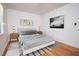 Bright bedroom with hardwood floors, a light gray bed, and matching bedside tables at 1002 Willow Drive Dr # 37, Chapel Hill, NC 27514
