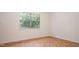 Empty bedroom has a parquet floor, neutral walls and a large sunny window at 1002 Willow Drive Dr # 37, Chapel Hill, NC 27514