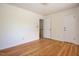 Empty bedroom featuring neutral walls, natural light, and gleaming hardwood floors at 1002 Willow Drive Dr # 37, Chapel Hill, NC 27514