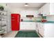 A modern kitchen with a retro red refrigerator, stylish green countertops and open shelving at 1002 Willow Drive Dr # 37, Chapel Hill, NC 27514