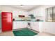 Bright kitchen boasts a SMEG refrigerator, white cabinets, and teal countertops at 1002 Willow Drive Dr # 37, Chapel Hill, NC 27514