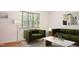 Elegant living room with parquet floors features modern furniture and a window with natural light at 1002 Willow Drive Dr # 37, Chapel Hill, NC 27514