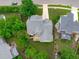 Aerial view of the property showcasing the backyard, mature trees, and driveway at 1004 Manderston Ln, Apex, NC 27502