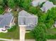 Aerial view of the home in a neighborhood, showcasing the roof and surrounding trees at 1004 Manderston Ln, Apex, NC 27502