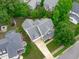 Aerial view of the home with a well-manicured lawn and mature trees at 1004 Manderston Ln, Apex, NC 27502