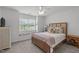 Bedroom features a window seat, a queen-sized bed, and natural light at 1004 Manderston Ln, Apex, NC 27502