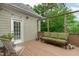 Outdoor deck featuring wood flooring, an outdoor sofa, string lights and partial shade at 1004 Manderston Ln, Apex, NC 27502