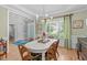 Bright dining room with light green walls, a modern light fixture, and a large window at 1004 Manderston Ln, Apex, NC 27502