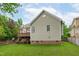 Exterior view of the home with a deck and a grassy backyard at 1004 Manderston Ln, Apex, NC 27502