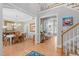 Elegant foyer with wood floors, open staircase, dining room view, and a glimpse of the kitchen at 1004 Manderston Ln, Apex, NC 27502