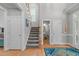Open foyer featuring a staircase, hardwood floors, and doorways to other rooms at 1004 Manderston Ln, Apex, NC 27502