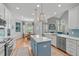 Bright, open kitchen features a center island, stainless steel appliances, and a breakfast nook with backyard views at 1004 Manderston Ln, Apex, NC 27502