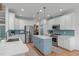 Well-lit kitchen showcases a center island, stainless steel appliances, and a blue backsplash for added elegance at 1004 Manderston Ln, Apex, NC 27502