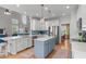 Open concept kitchen offers a large island, modern appliances, a sink, and an inviting eat-in area at 1004 Manderston Ln, Apex, NC 27502