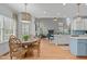 The open-concept kitchen with breakfast nook has lots of light and a view of the living room at 1004 Manderston Ln, Apex, NC 27502