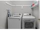 Functional laundry room with modern washer and dryer, overhead shelving, and ample storage at 1004 Manderston Ln, Apex, NC 27502